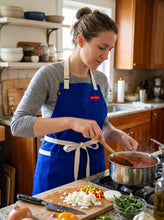 Load image into Gallery viewer, Girl wearing purple apron
